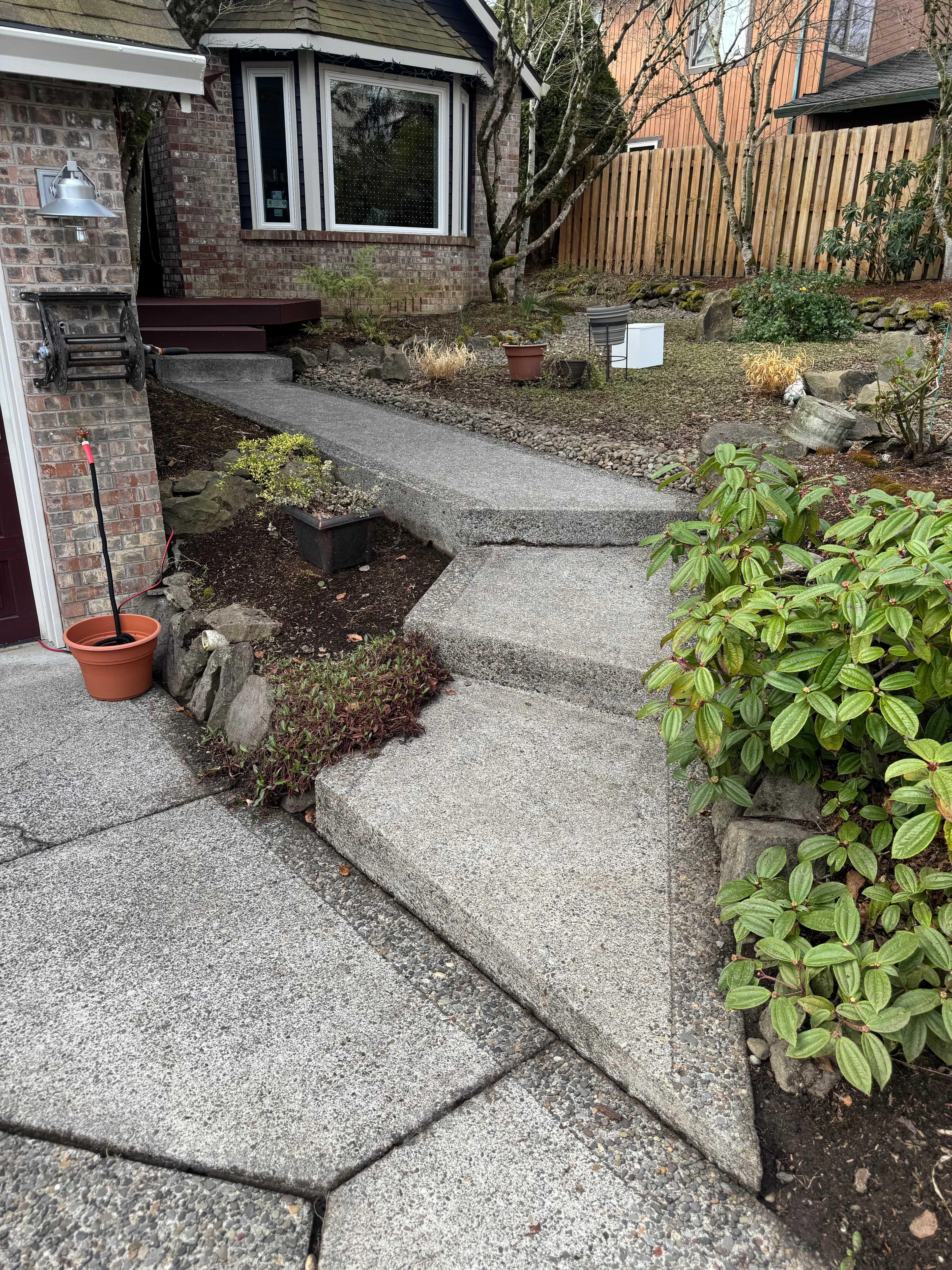 After cleaning stone walkway with brighter concrete.