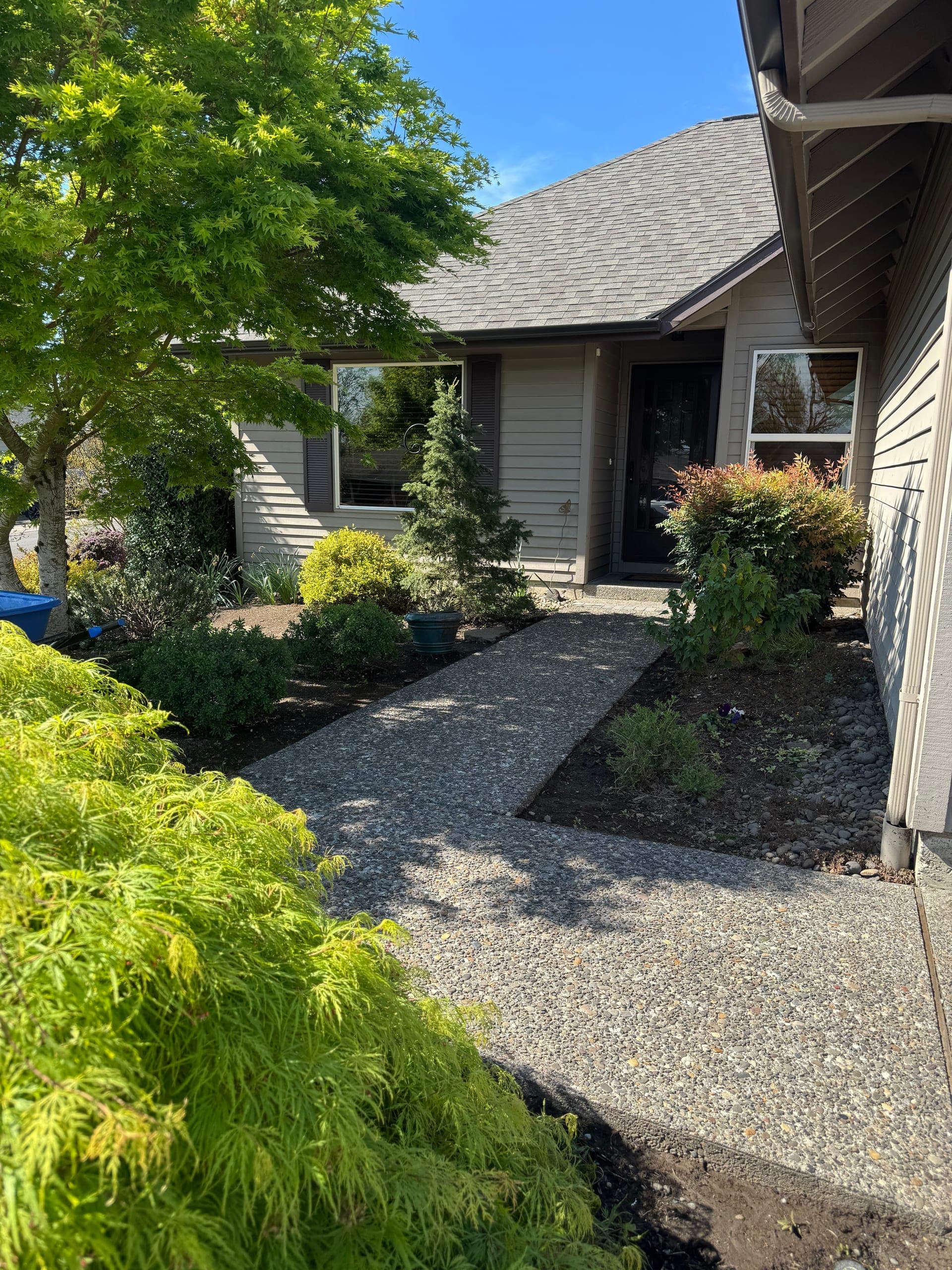 Clean aggregate walkway along a home.